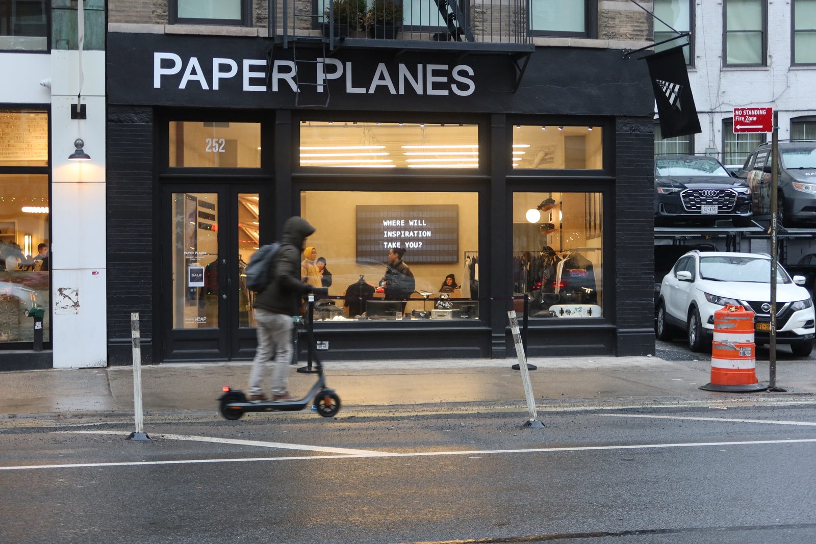 The Paper Planes flagship store on Lafayette Street, New York, with a split-flap board visible through the window