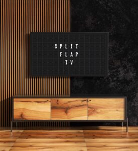 a split flap television hanging on the wall showing split flap messages