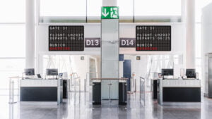 flight information on split flap televisions at the gate of an airport