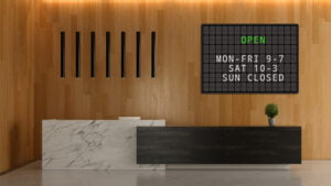opening hours on a splitflap tv hanging on the wall