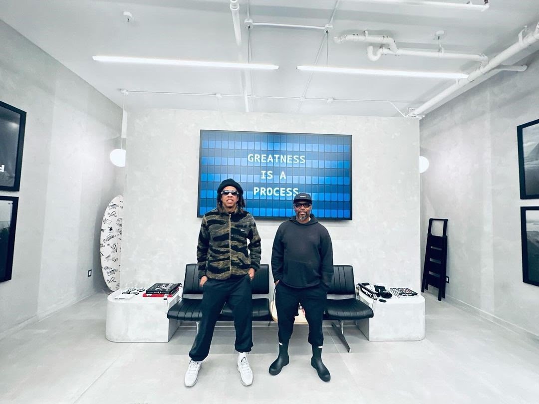 Jay Z at his Paper Planes NY flagship store standing in front of a large Split Flap TV